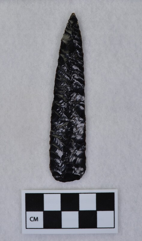 Parallel diagonal flaking to midsection, basal thinning and light grinding