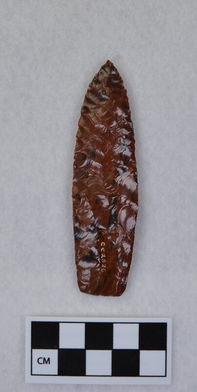 Parallel diagonal flaking, heavily ground basal margin, lanceolate style