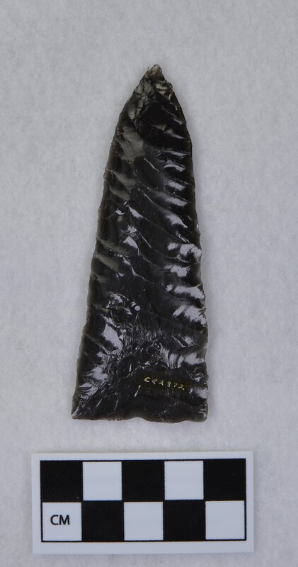 Broad lanceolate style, parallel diagonal flaking, basal thinning and grinding