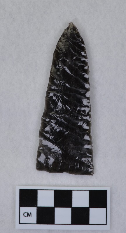 Broad lanceolate style, parallel diagonal flaking, basal thinning and grinding