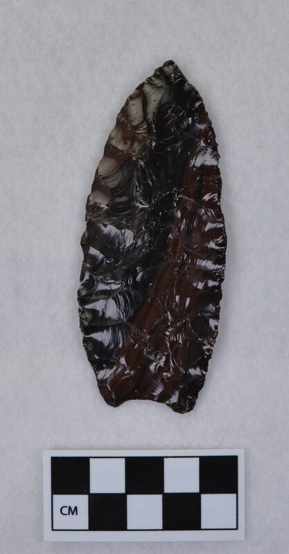 Large broad parallel flaking, concave base