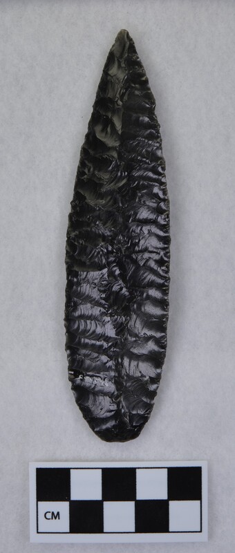 Flaked to midsection to form dorsal ridge, lanceolate style point, ground and thinned basal margins