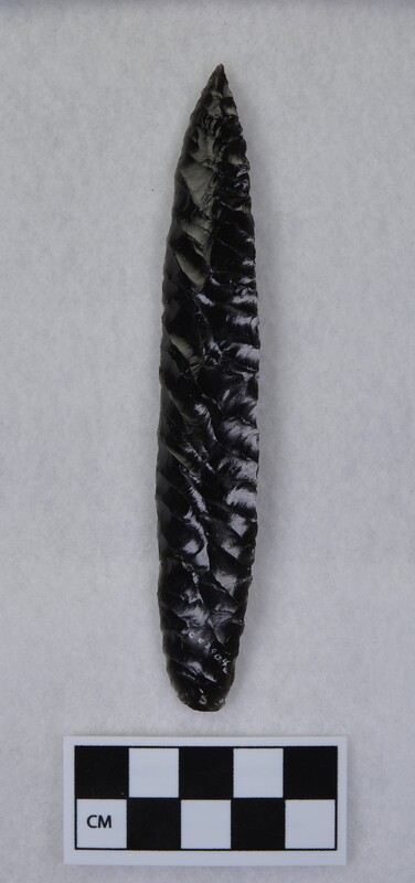 Obsidian biface created by Donald E. Crabtree using obsidian from Glass Butte, Oregon. The flakes terminate along a well-defined median ridge. Due to the use of a palm block while pressure flaking. (JW)