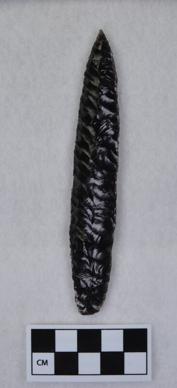 Obsidian biface created by Donald E. Crabtree using obsidian from Glass Butte, Oregon. The flakes terminate along a well-defined median ridge. Due to the use of a palm block while pressure flaking. (JW)