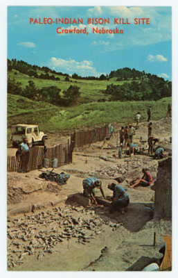 Front: photograph of a portion of the Paleo-Indian Bison Kill Site in Crawford Nebraska. Excavation workers can be seen in the photo. Back: details of the excavation site and event.