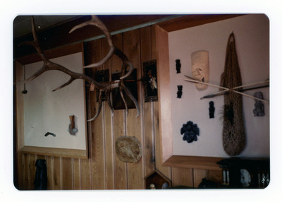The front of a postcard decorated with a picture of a display of indigenous artifacts.
