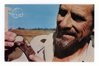 The front of a postcard decorated with a picture of Dr. Carl Gustafson holding a bone projectile point.