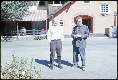 A photographic slide of Don E. Crabtree and Francois Bordes standing in front of the Challenger Inn.