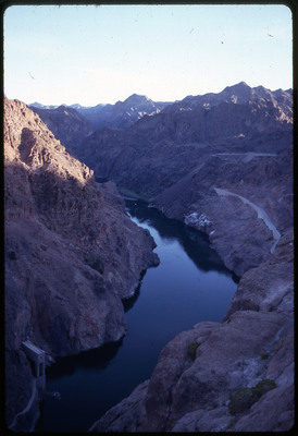 A photographic slide of a river running through a series of rocky peaks.