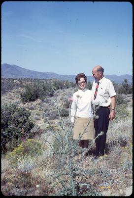 A photographic slide of Evelyn and Don E. Crabtree hugging in a field of desert wildflowers.