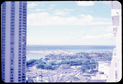 A photographic slide of a scenic view of an ocean beach taken from a tall building.