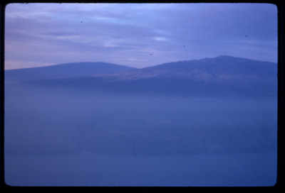 A photographic slide of an aerial view of a lake and surrounding hills.