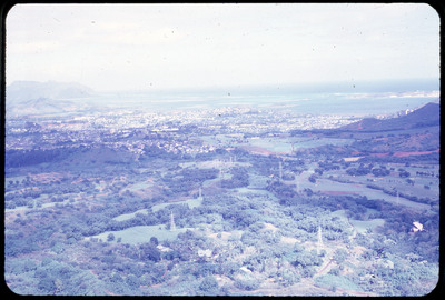 A photographic slide of a scenic view of the outskirts of a city.