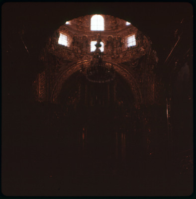 A photographic slide displaying the ornate interior of a cathedral. The entire slide is oversaturated and tinted red.