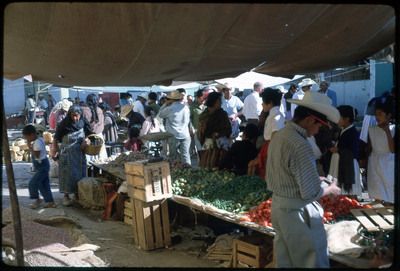 A photographic slide of a crowded outdoor marketplace.
