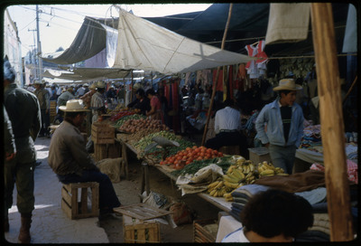 A photographic slide of a crowded outdoor marketplace.
