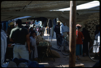 A photographic slide of a crowded outdoor marketplace.