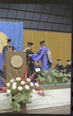 A photo of a group of people, including Donald Crabtree, onstage at a graduation ceremony at the University of Idaho.