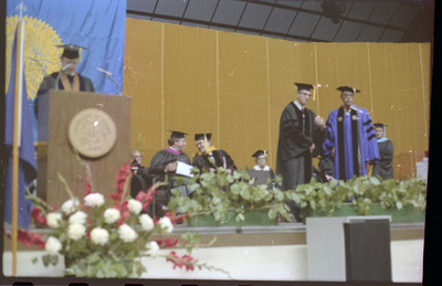 A photo of a group of people, including Donald Crabtree, onstage at a graduation ceremony at the University of Idaho.