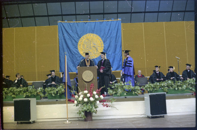 A photo of a group of people, including Donald Crabtree, onstage at a graduation ceremony at the University of Idaho.
