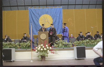 A photo of a group of people, including Donald Crabtree, onstage at a graduation ceremony at the University of Idaho.