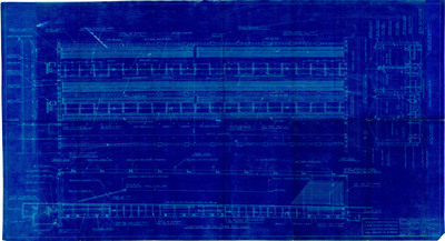 Detail of dry kiln machinery. This conveyor system moved wet, or green, lumber through a kiln designed to blast the wood with heated air via the cylindrical fan system. At the end of the structure, the lumber was off-loaded and stored for final sale.