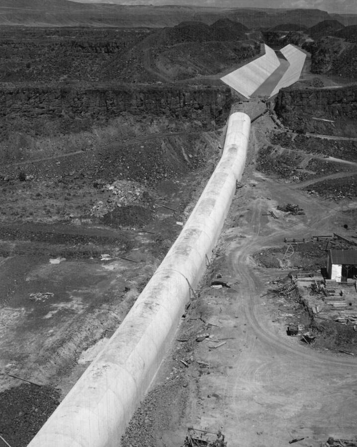 Columbia Basin Project. Irrigation Division. Bacon Siphon, Specifications 1236, T.E. Connolly Inc., Contractor. Bacon Siphon and Main Canal looking upstream from top of cliff above inlet to the Bacon Tunnel. Canal is completed with inlet structure of the siphon yet to be done.