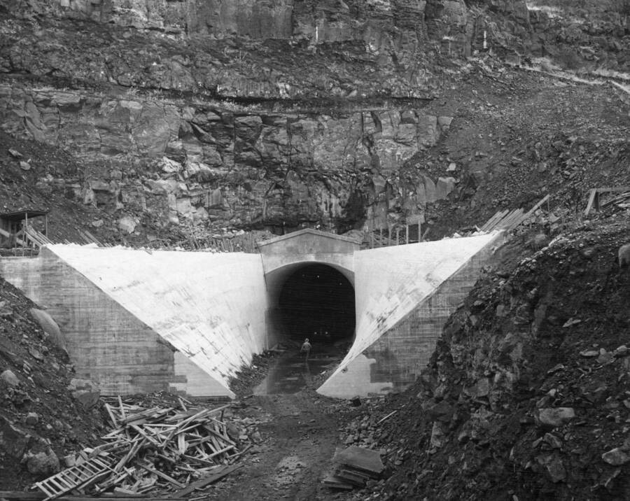 Columbia Basin Project. Irrigation Division, Bacon Tunnel, Specifications 1236, T.R. Connolly, Inc., Contractors. Looking upstream at the outlet portal of Bacon Tunnel portal structure and open transition is complete except for backfilling and cleaning up operations