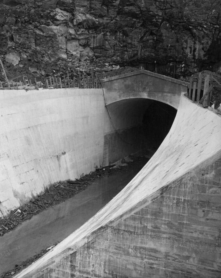 Columbia Basin Project. Irrigation Division, Bacon Tunnel, Specifications 1236, T.E. Connolly, Inc., Contractor. Looking upstream at the outlet portal of the Bacon Tunnel. Portal Structure and open transition is complete except for backfilling and cleaning up operations.