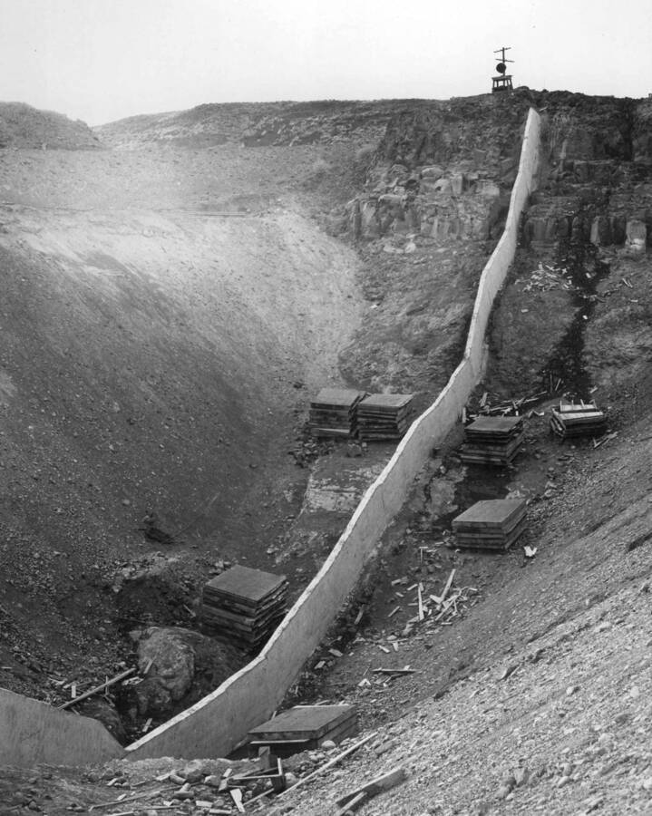 Columbia Basin Project, Irrigation Division, Long Lake Dam. Spec. #1401--J.A. Terteling and Sons, Contractor. Looking west at west abutment showing cut-off wall and rock fracture at Station 8+00. Long Lake Dam is two miles northeast of Stratford, Wash. Harold Foss, photographer.