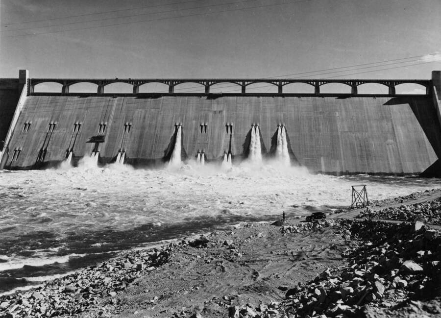 Spillway section of the dam as seen from the left bank near the shop building. Note the man and care at the waterline. (normal)