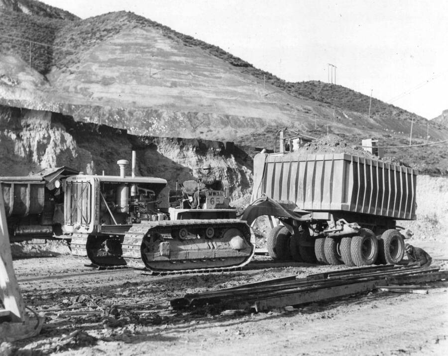 Caterpillar hauls away materials during the excavation of Grand Coulee site.