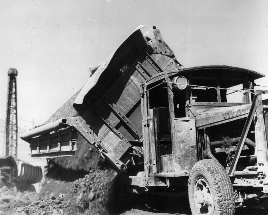 Close up view of a dump truck dumping material during excavation operations.