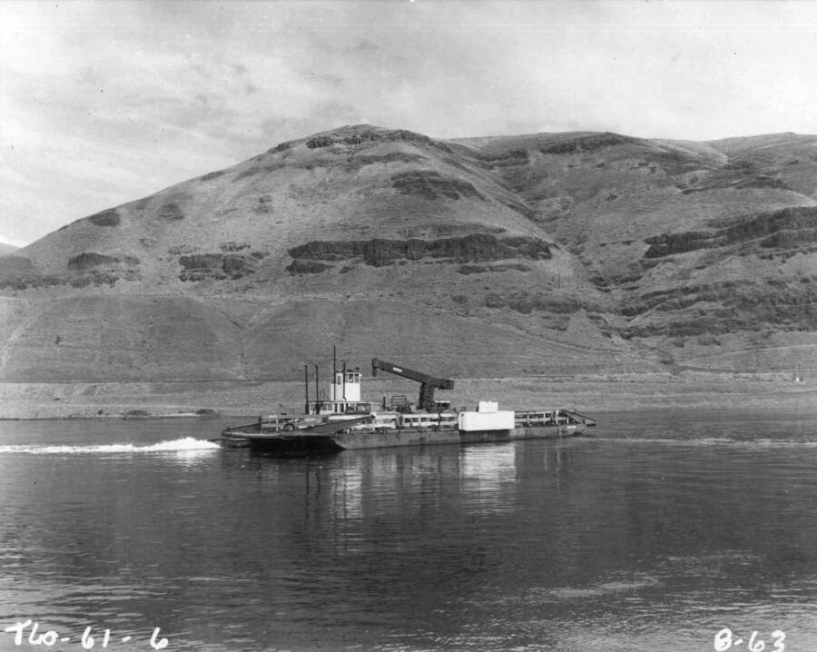 In addition to a fleet of trucks, the Guy F. Atkinson Company of San Francisco, California, holder of the first stage construction contract at the U.S. Army, Corps of Engineers' Little Goose Lock and Dam site, has assigned two work barges with tugs. The fabrication of the cofferdam cells riverward from the work area behind which the Little Goose Dam will be constructed, is being carried on the high ground of what was once Little Goose Island. The barges and tugs are necessary to transport equipment from the south shore to Little Goose Island, where the cofferdam cell fabrication is underway. With completion of the cells, the Snake River will be diverted by an earthen embankment towards the north-shore, where and excavated diversion channel has been created.