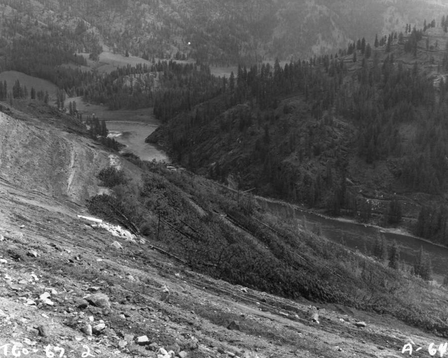 Clearing timber from the land at the U.S. Army Corps of Engineers Dworshak (Bruces Eddy) Dam site on the North Fork of the Clearwater River is well underway. Dworshak Dam will set across the river about the center of the picture and will climb to a height of 673 feet.
