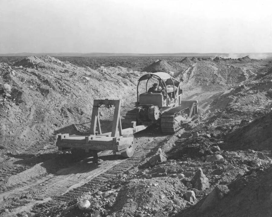 Columbia Basin Project, Irrigation Division, Third Section West Canal, Specifications 2844, Schedule 3. Looking downstream at approximate station 2015.00 at caterpillar dozer with one tooth ripper doing rough excavation for chute. Winnin and Shilling--contractor. H. E. Foss--photographer.