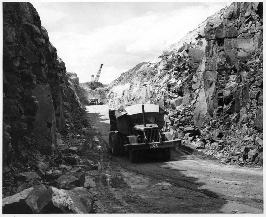 Columbia Basin Project, Irrigation Division, 1st section, Potholes East Canal, Specs. 2787. 54 B dragline excavating shot rock and loading into 18 cy. Yd. dump trucks hauling and wasting on right of station 231/00. Work is being performed by Guy F. Atkinson Co. under above specifications. H. E. Foss, photographer.