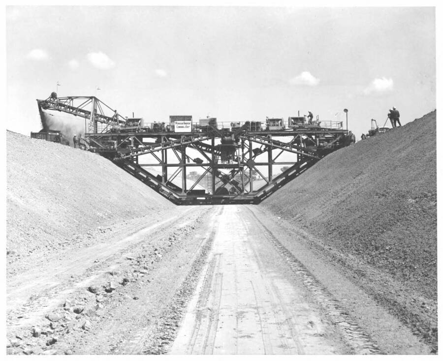 Columbia Basin Project, Irrigation Division, 2nd Section West Canal, Specs. 2541. Guntert and Zimmerman trimmer (front view) at about station 1050. This machine is trimming the canal bottom and slopes to the neat line of the underside of the concrete lining. Work is being performed by Morrison-Knudsen, Inc. under Schedule 2 of the above Specifications. H.E. Foss, photographer