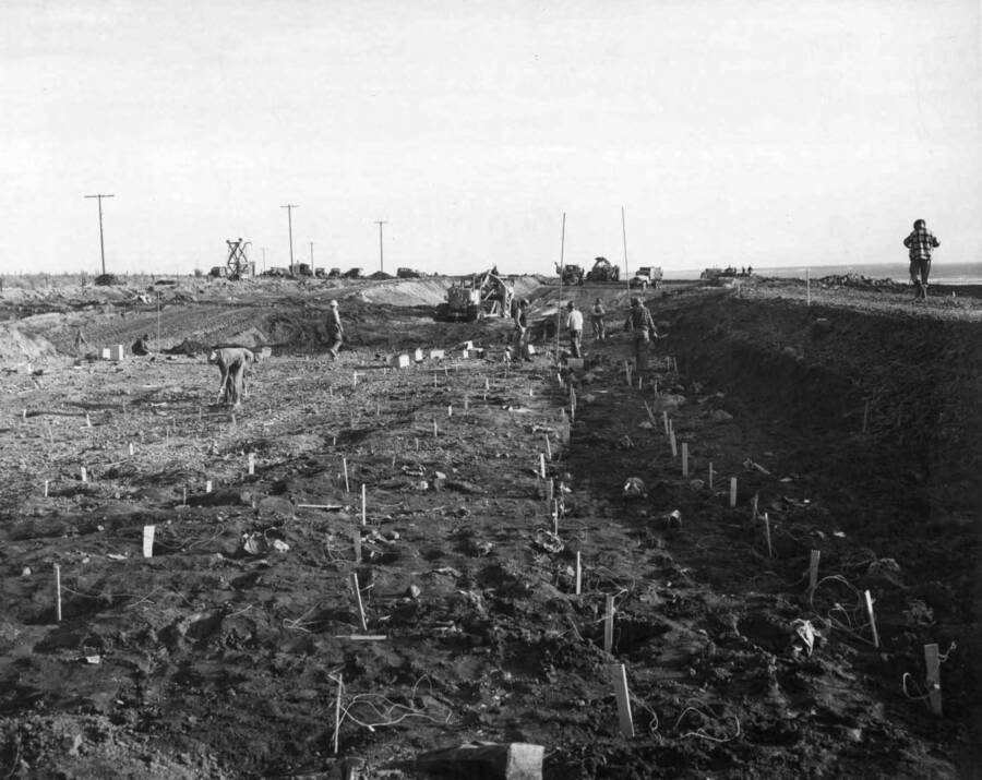 Columbia Basin Project, Irrigation Division. West Canal. Spec. #1286--Utah Construction Co. and Winston Bros. Co. Contractor. View of canal section, looking east from station 256, shows rock drilled and loaded and nearly ready for shooting. Located approx. 2 miles east of Soap Lake, Wash. Taken by request of F.S. Arnold, resident engineer, for record purposes.