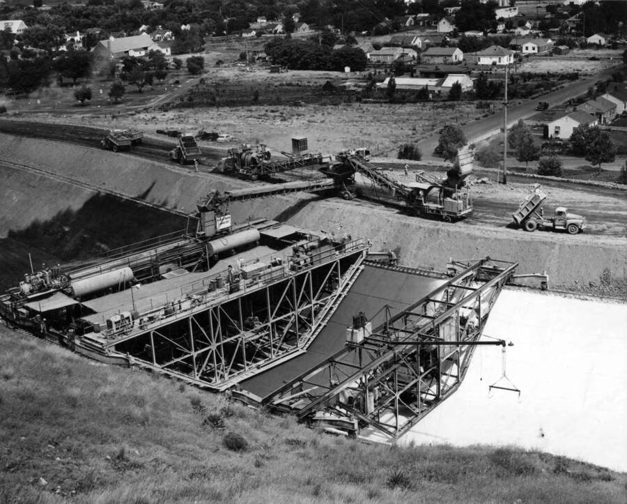 Columbia Basin Project--Irrigation Division, 2nd Section West Canal, Specs. 2541. Lining the canal through the city of Ephrata at about Station 757. Work is being performed by Morrison-Knudsen, Inc. under Schedule 2 of above Specifications. H.E. Foss, photographer.