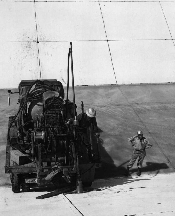 Columbia Basin Project--Irrigation Division, 2nd Section West Canal, Specs. 2541. Diamond drill crew taking a sample of the lining for visual inspection of the concrete and grooves. Work is being performed by government forces from Coulee Dam. H.E. Foss, photographer.