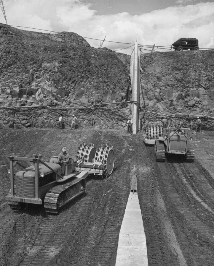 South Coulee Dam--Embankment placing operations, stations 33+50 to 34+50, approximate elevation 1499. Closeup of standard and narrow-drum rollers, showing effect of cleaners. Approximate needle moisture reading of 2700