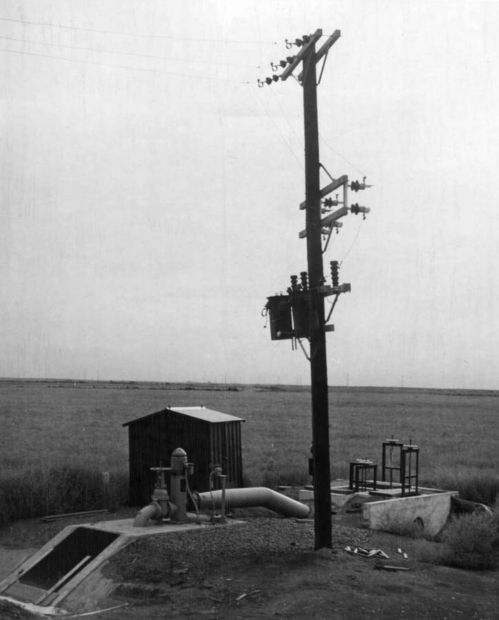 PP-8.0 relift pump of 3H.P. used to deliver 3 cu. Ft./sec. to two farm units. Temporary electrical equipment installed on pole structure for 1948 irrigation season. Portable sheet metal house behind house will be set over installation for protection against weather. A.F. Swanson, cameraman