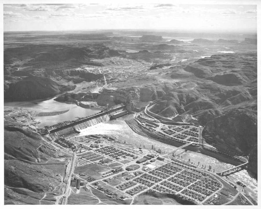 A distant view of Grand Coulee Dam showing the employee housing along the Columbia River, in Grand Coulee, Washington April 21, 1940.