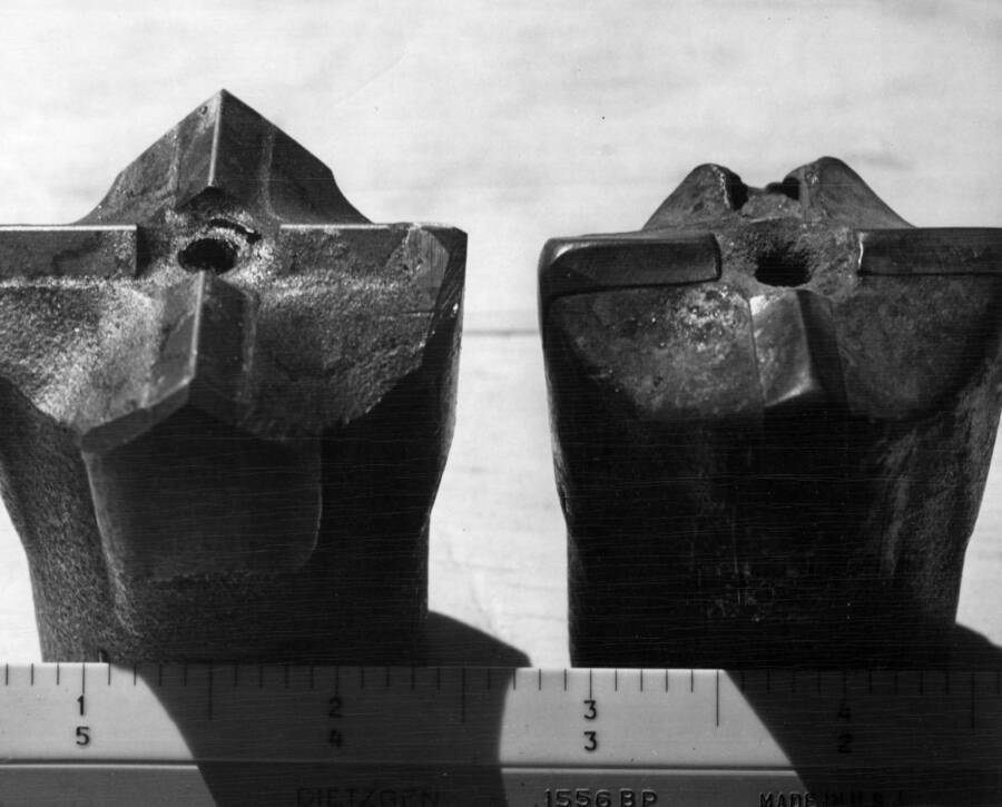 Columbia Basin Project, Irrigation Division, Soap Lake Siphon, Specifications 2411, Utah Construction Company and Winston Bros. Co., Contractor. This photograph of two 2-inch I.R. insert bits. The one on the left is new. The one on the right has drilled approximately 1,000 lin. feet of basalt. The absence of one cutting edge does not lower the drilling rate appreciably. Mr. L. Moore the I.R. representative said the bit would work better if the opposite insert was knocked out. H.E. Foss, photographer