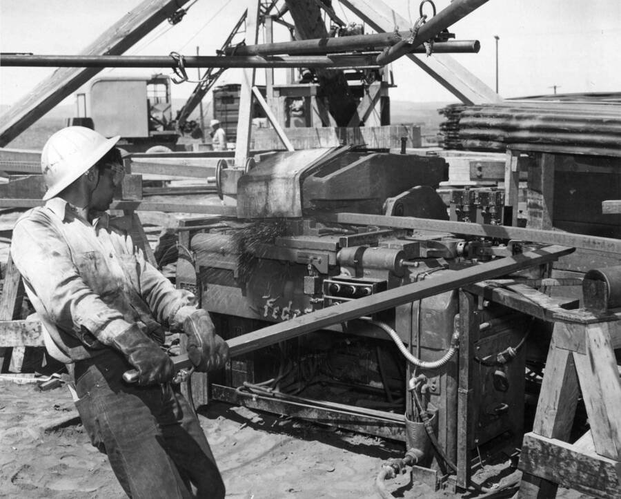 Columbia Basin Project, Irrigation Division, West Canal. Spec. #1286--Utah Construction Co. and Winston Bros. Co. contractor. View of flash-pressure welding machine in operation, welding 1-3/4' square reinforcing hoop. A.W. Bauman, photographer.