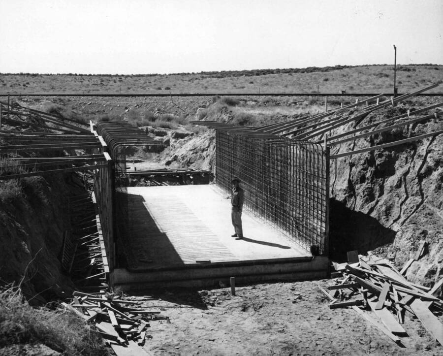 Columbia Basin Project, Irrigation Division, 3rd Section East Low Canal and Weber Wasteway, Specs. 2879. Forms and reinforcing steel for culvert, Weber Wasteway Sta. 88+97.28, under Chicago, Milwaukie, St. Paul and Pacific Railway. Shoofly in the background. View looking south. Work being done by Western Contracting Corporation. H.E. Foss, photographer.