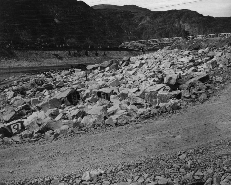 View towards northwest from deflection sheave #5, showing large rocks on riprap with their identifying numbers painted on them. A similar photo taken after 1948 high-waster will show to what extent the large rocks are moved by the high water. See book #143, page #39, for location of rocks.
