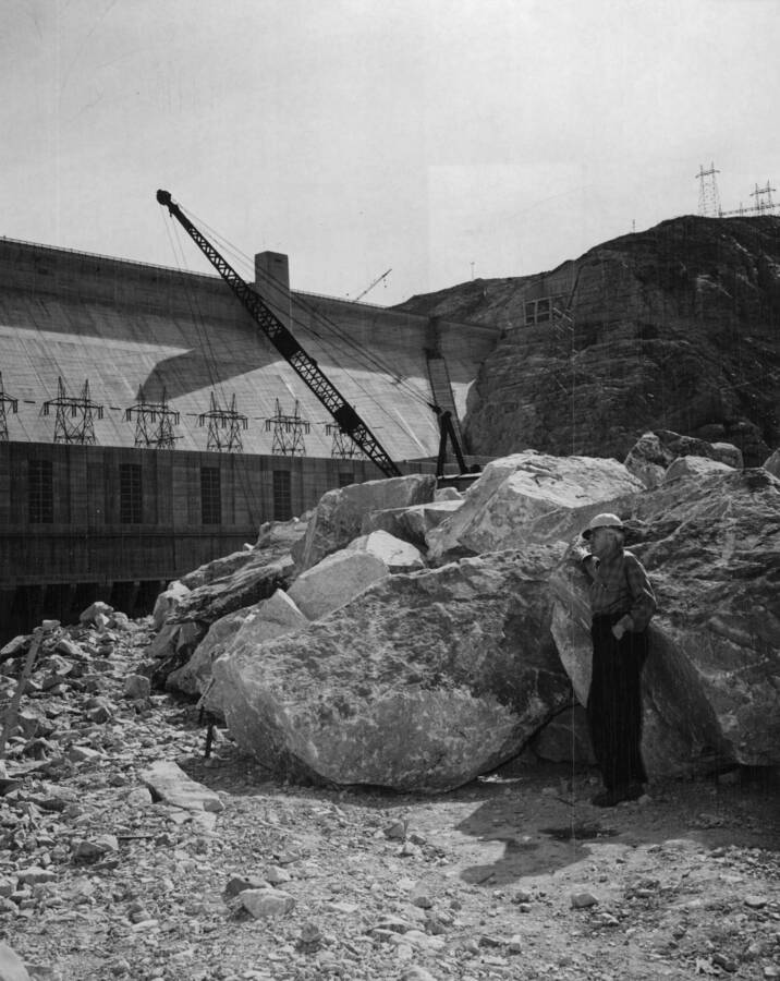 First placement of granite armor rock at the downriver end of section 'A.' Note the size of the rock in comparison to the man; armor rock weighing over 10 tons has been placed. This rock is obtained from the upriver quarry under work performed by J.A. Terteling and Sons, Inc., under provisions of negotiated contract I2r-18456