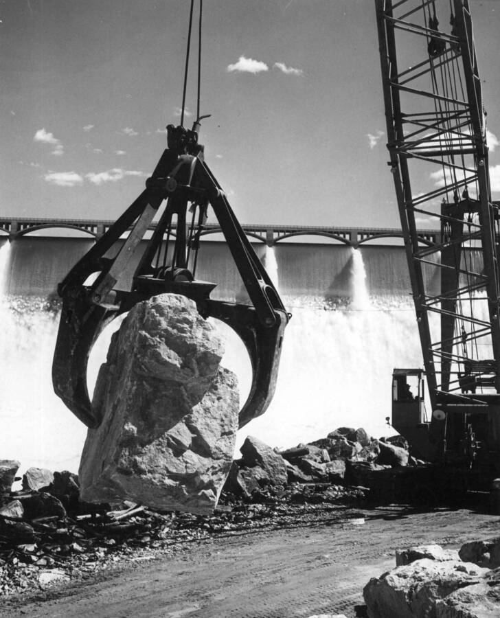 The Bucyrus-Erie electrical shovel loading riprap from the quarry, into a 20-yard Euclid truck. Specifications No. 2808, River Channel Improvements. Contractor: Morrison Knudsen Company, Inc. Grand Coulee Dam, Columbia Basin Project, Washington